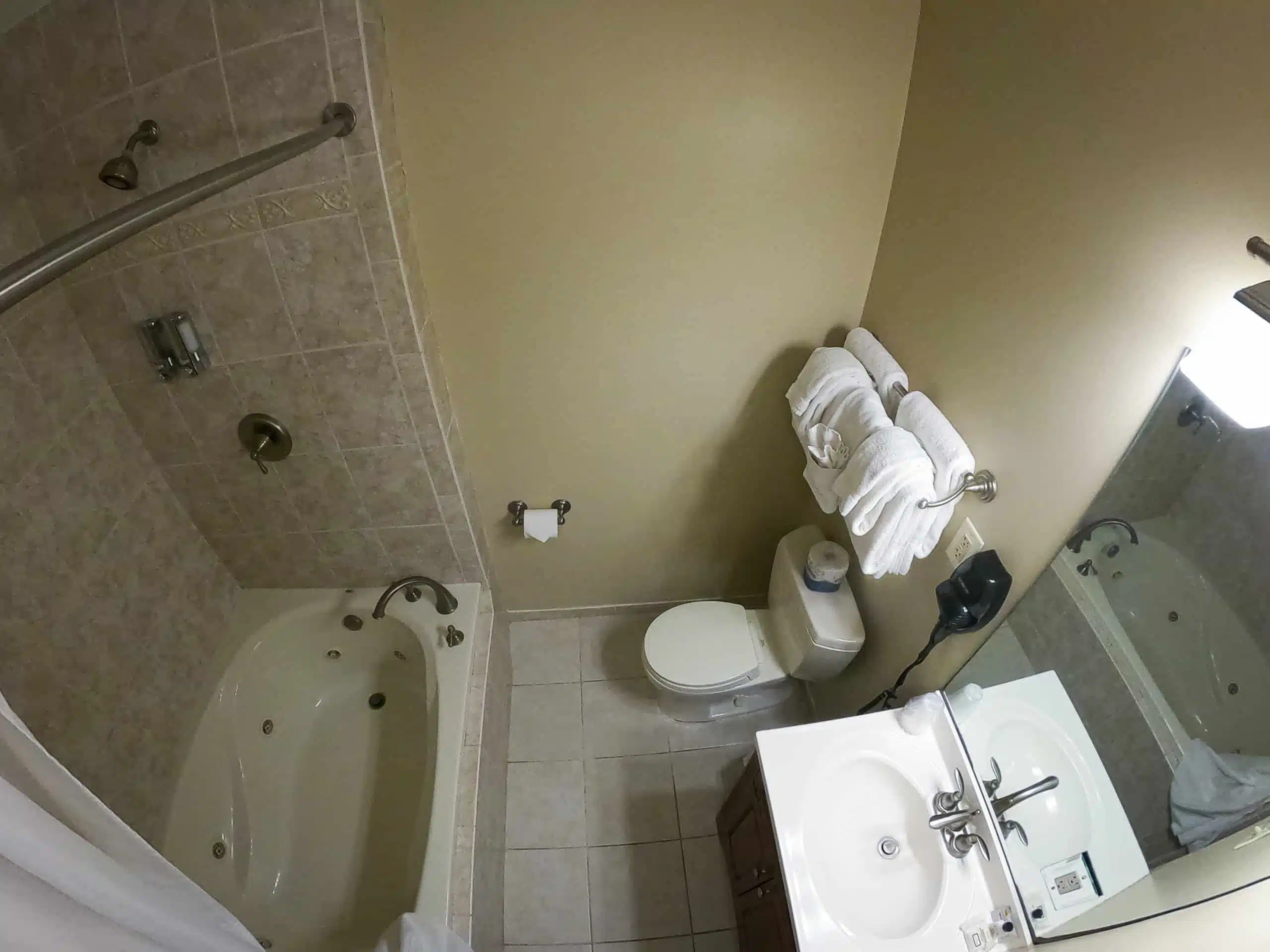Spacious bathroom featuring an oversized tub with jets, shower, large vanity, and plush towels at Otsego Resort chalet.
