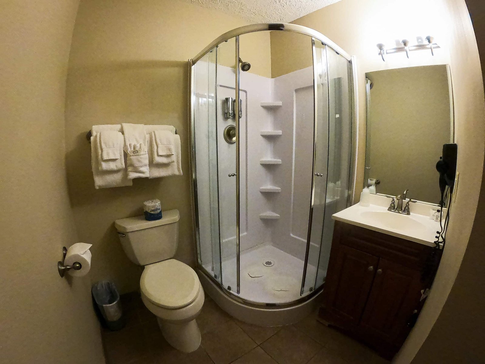 Bathroom featuring a glass shower, toilet, and vanity with sink, showcasing spa amenities and a clean, spacious design typical of Otsego Resort chalets.